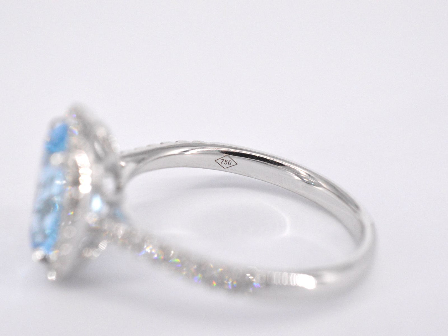 White gold entourage ring with oval cut topaz