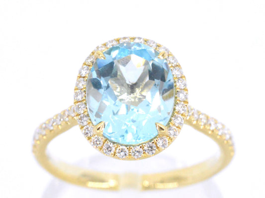 Gouden entourage ring met ovaal geslepen topaas