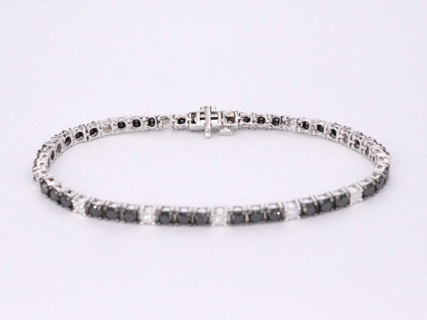Witgouden tennisarmband rondom gezet met zwarte en witte diamanten