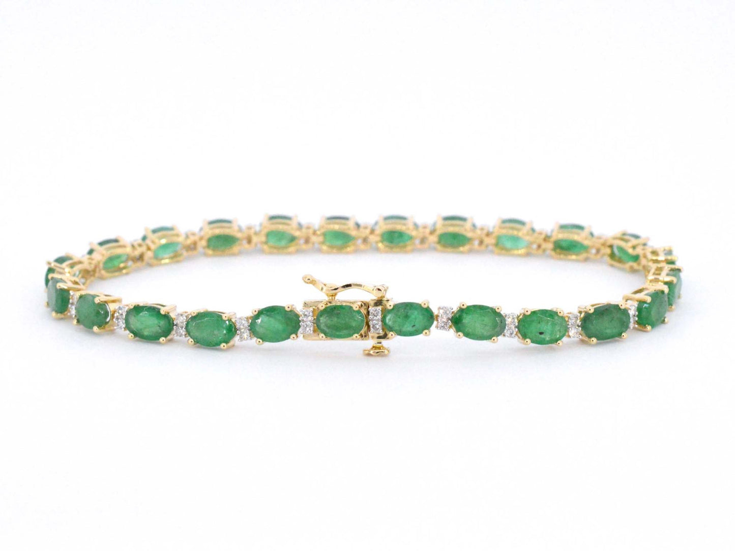 Geelgouden tennisarmband met diamanten en smaragden