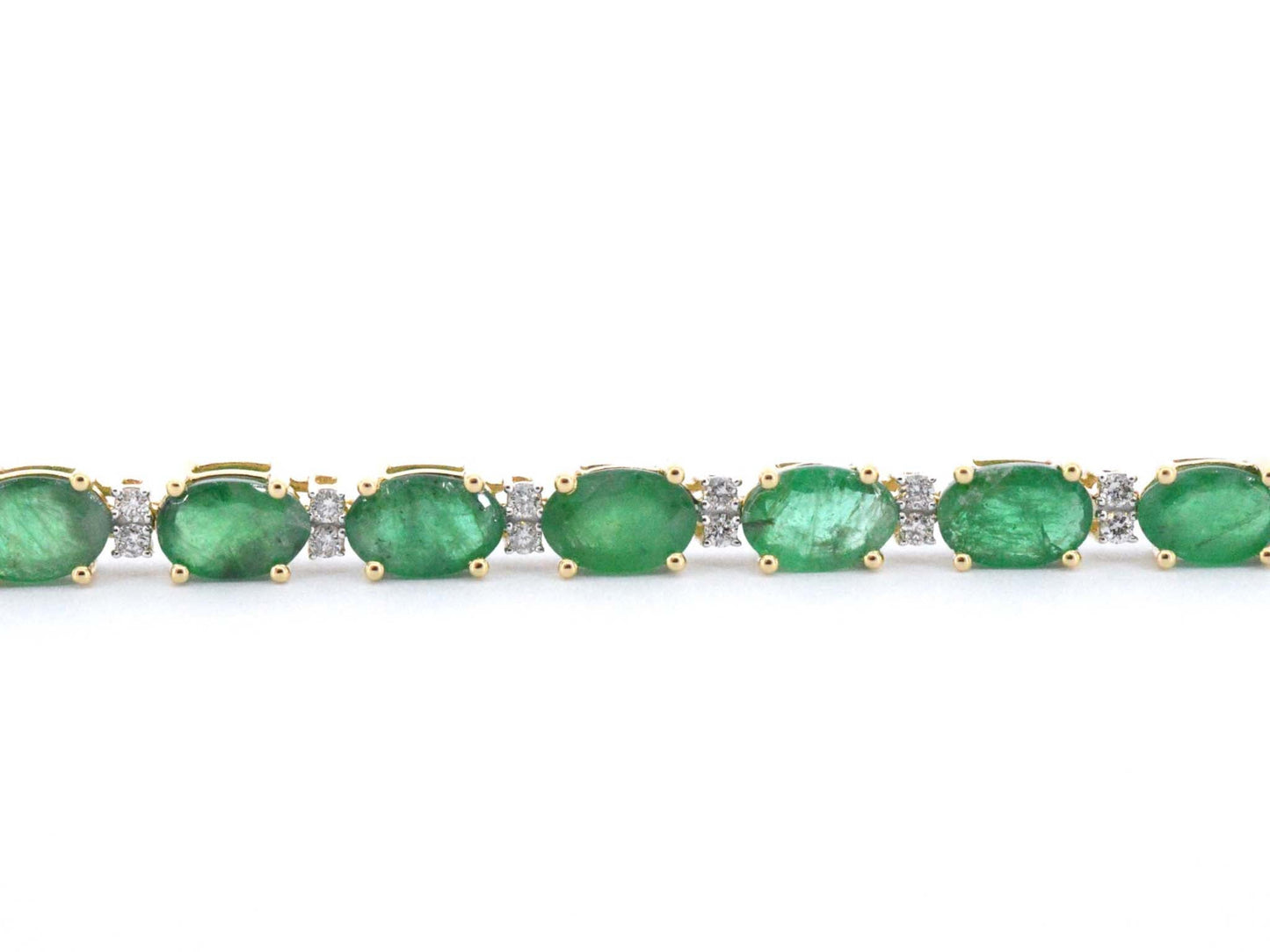 Geelgouden tennisarmband met diamanten en smaragden