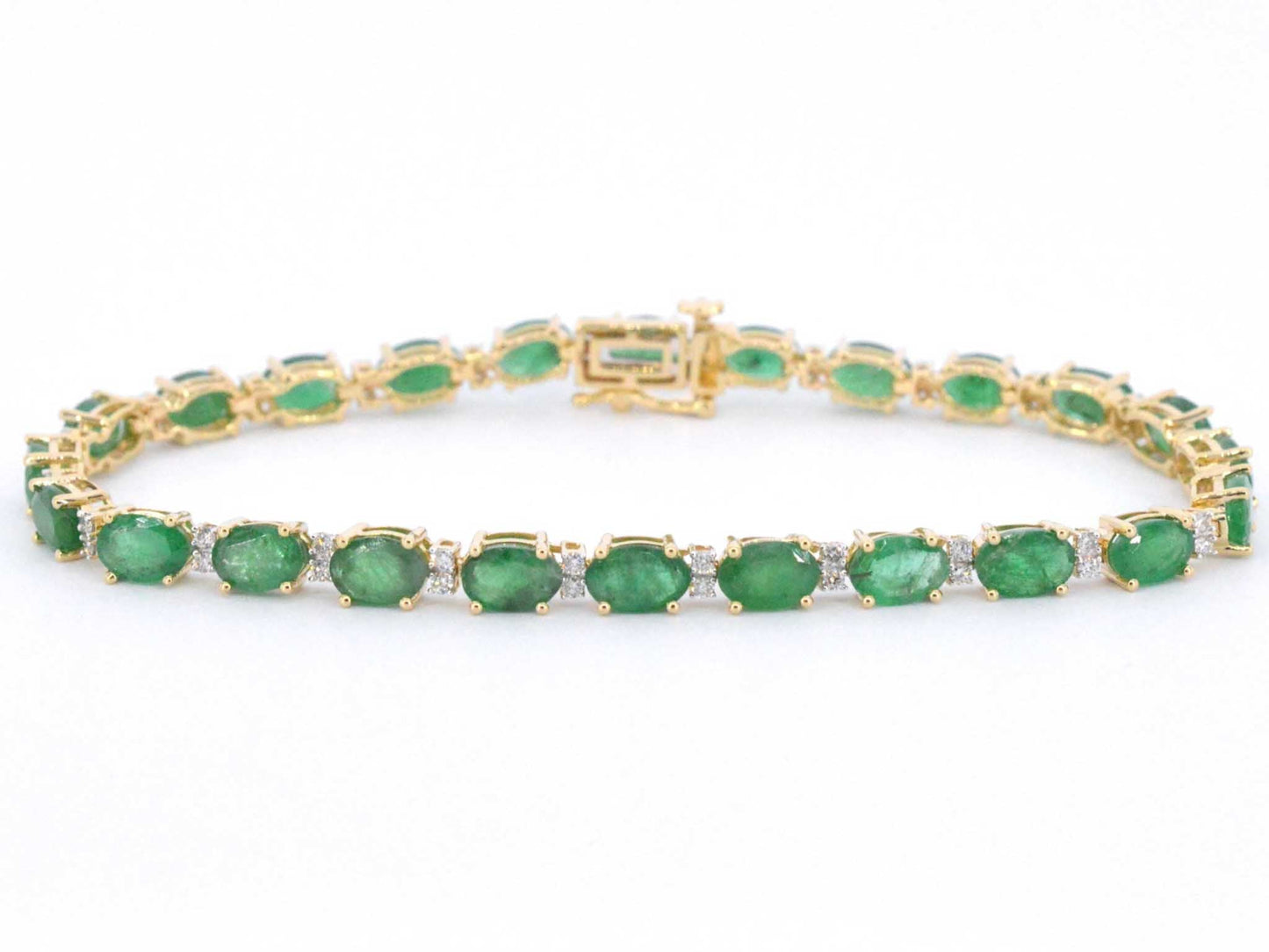 Geelgouden tennisarmband met diamanten en smaragden