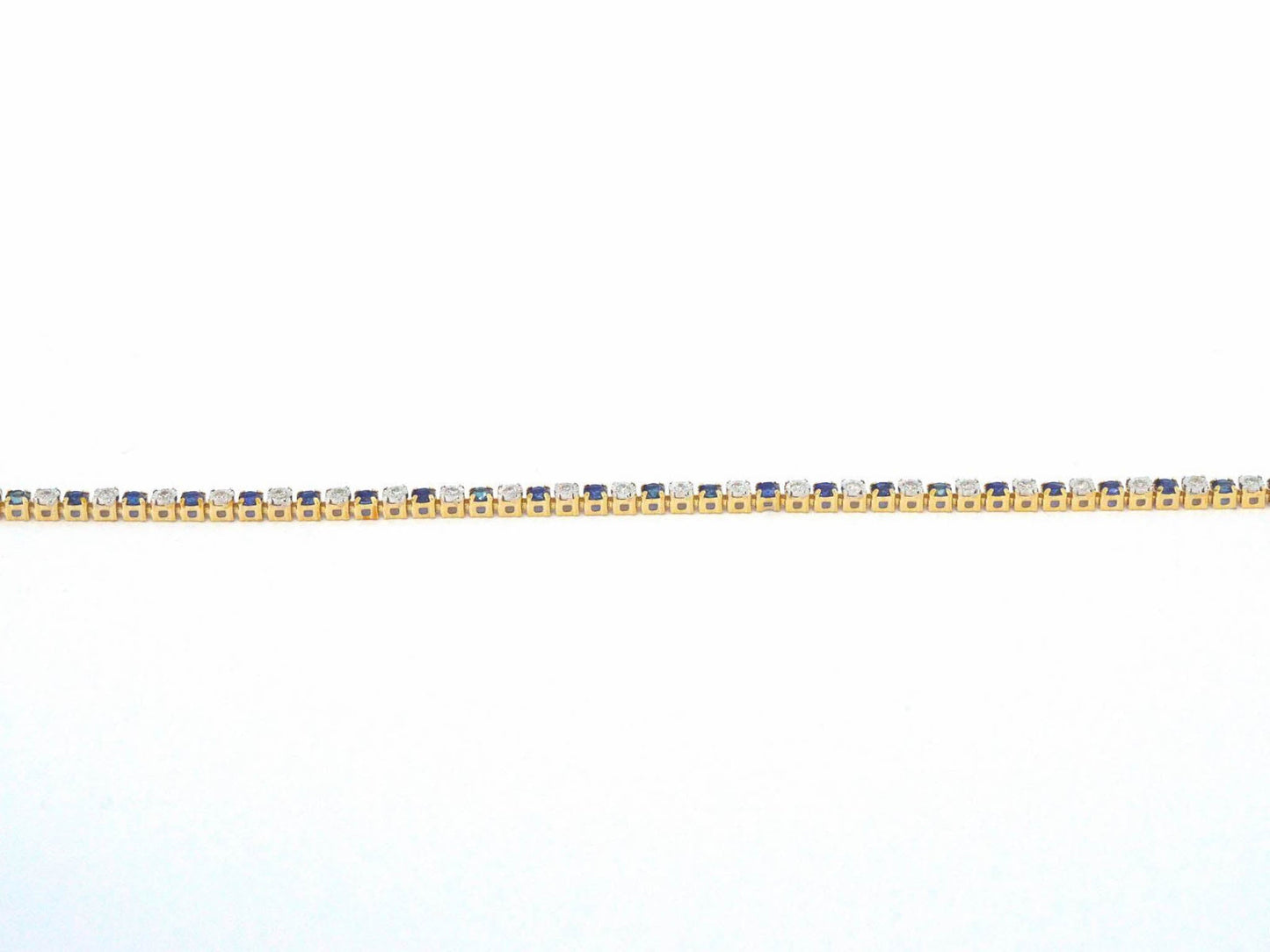 Gouden tennis armband met diamanten en saffieren