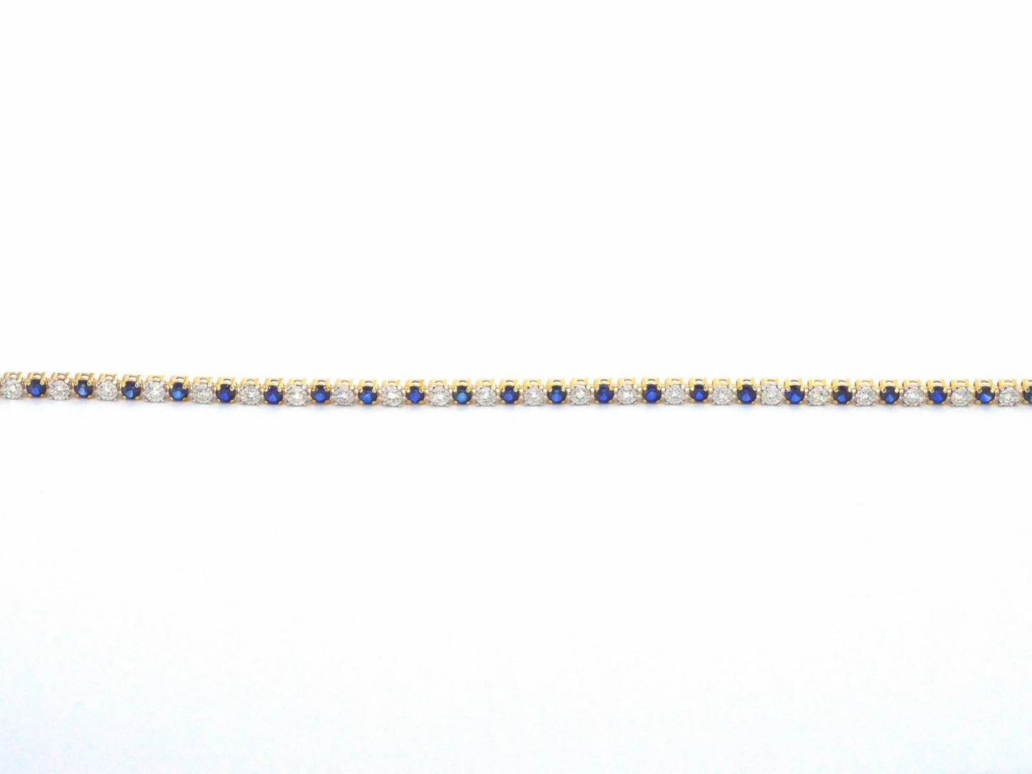 Gouden tennis armband met diamanten en saffieren