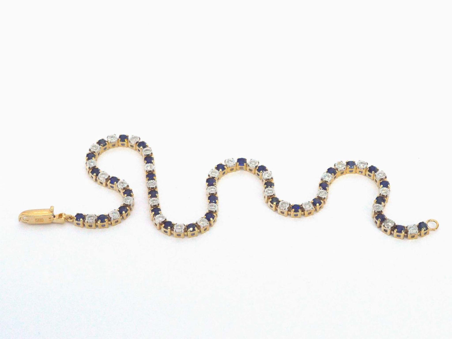 Gouden tennis armband met diamanten en saffieren
