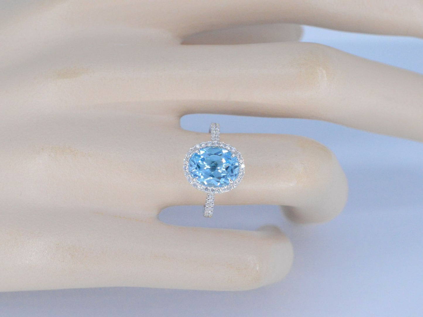 White gold entourage ring with oval cut topaz