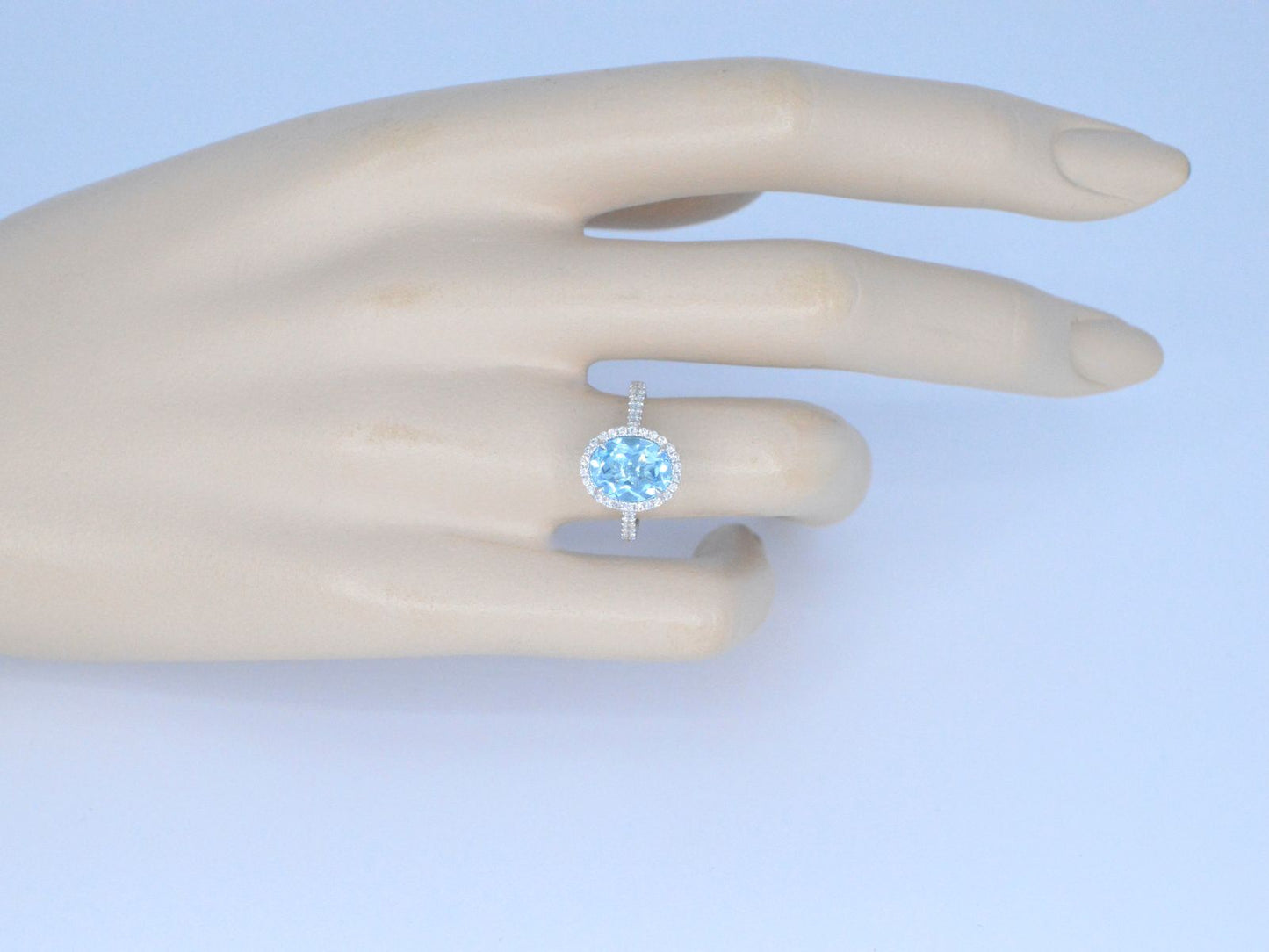 White gold entourage ring with oval cut topaz