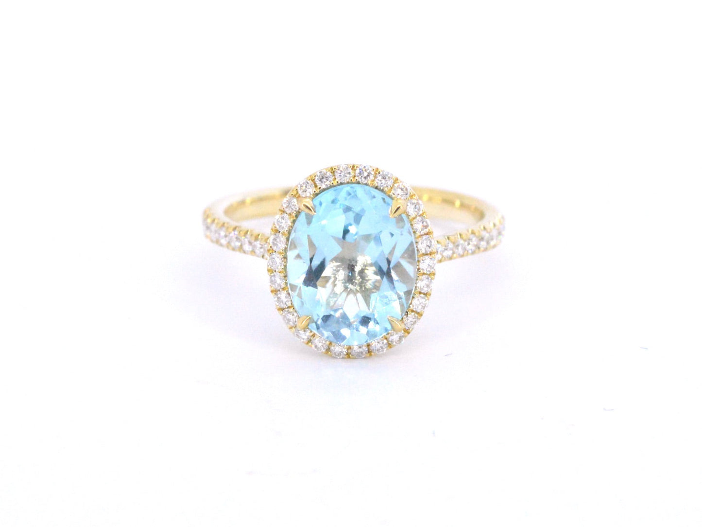 Gold entourage ring with oval cut topaz