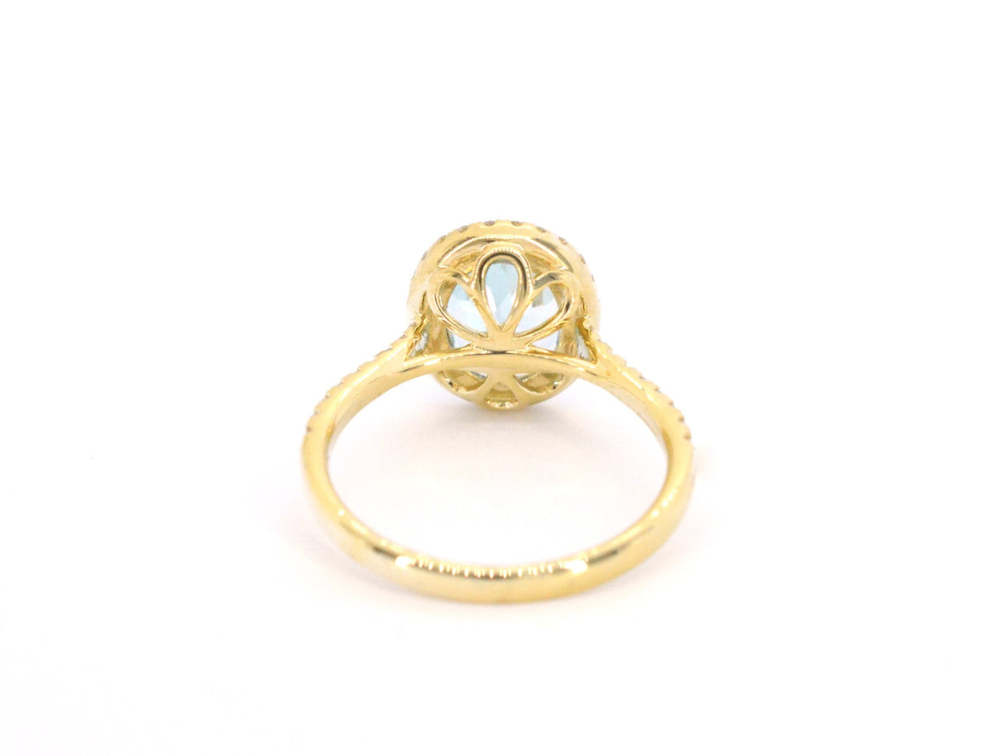 Gold entourage ring with oval cut topaz