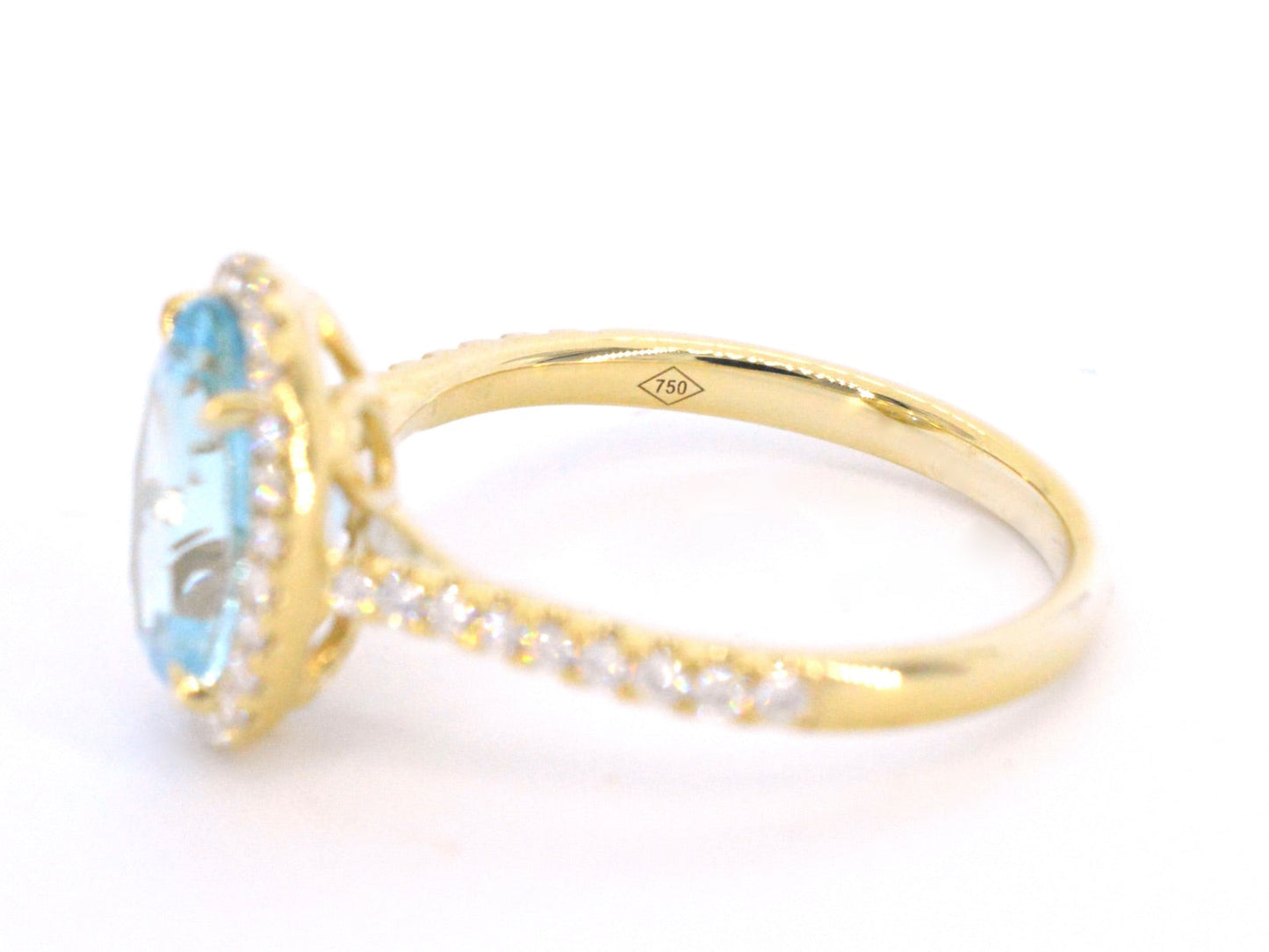 Gold entourage ring with oval cut topaz