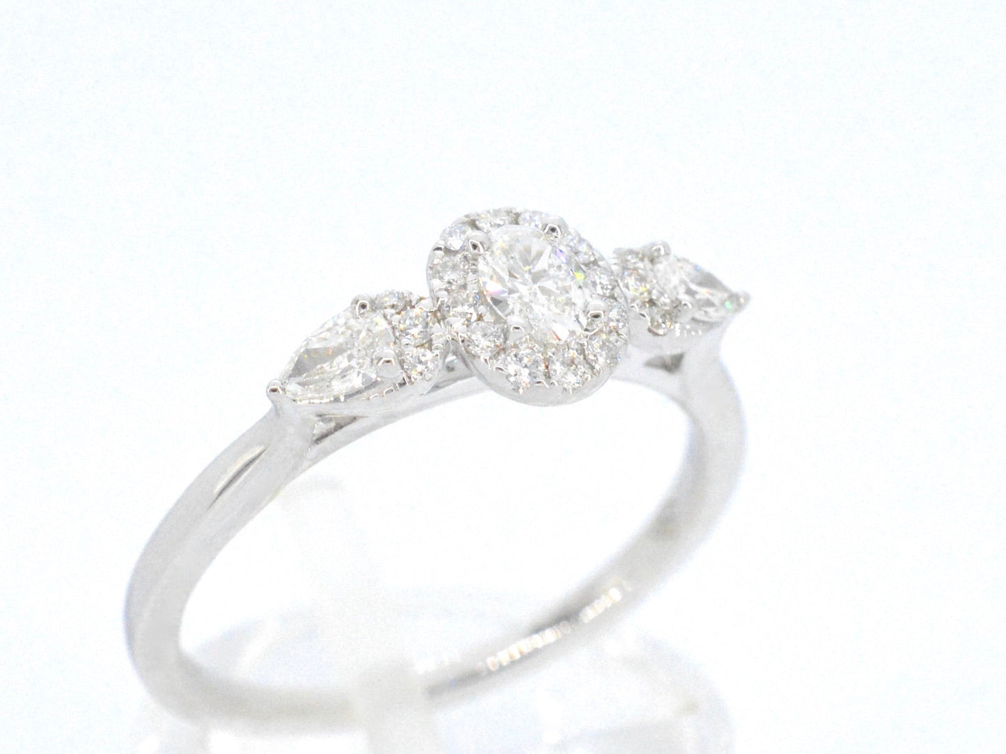 White gold ring with diamonds and an oval cut diamond