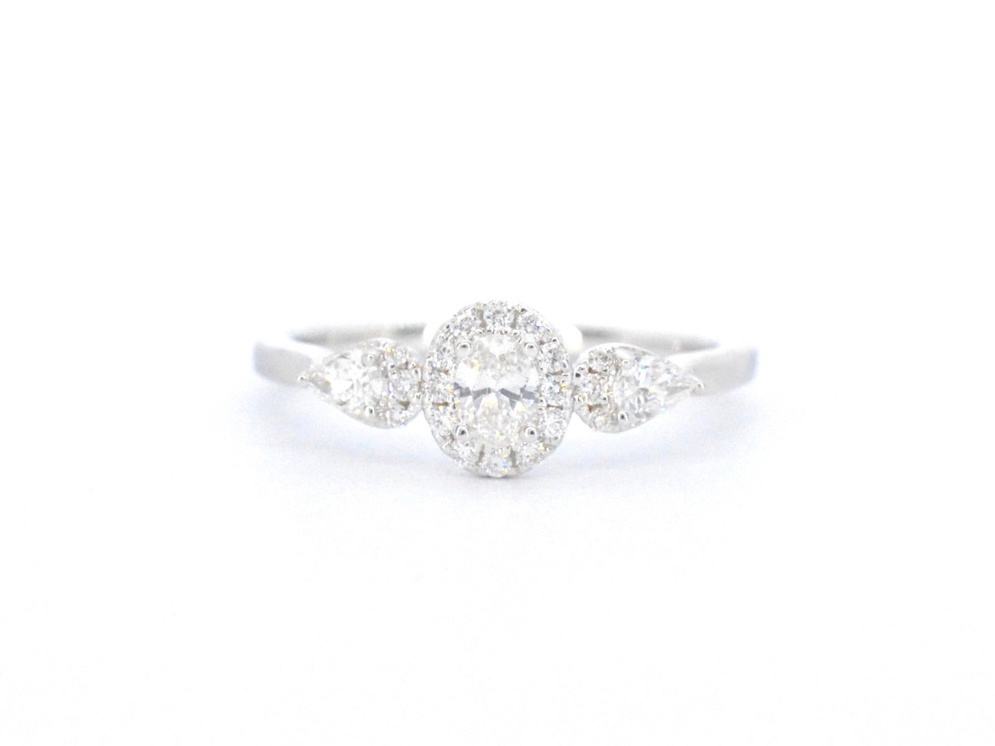 White gold ring with diamonds and an oval cut diamond