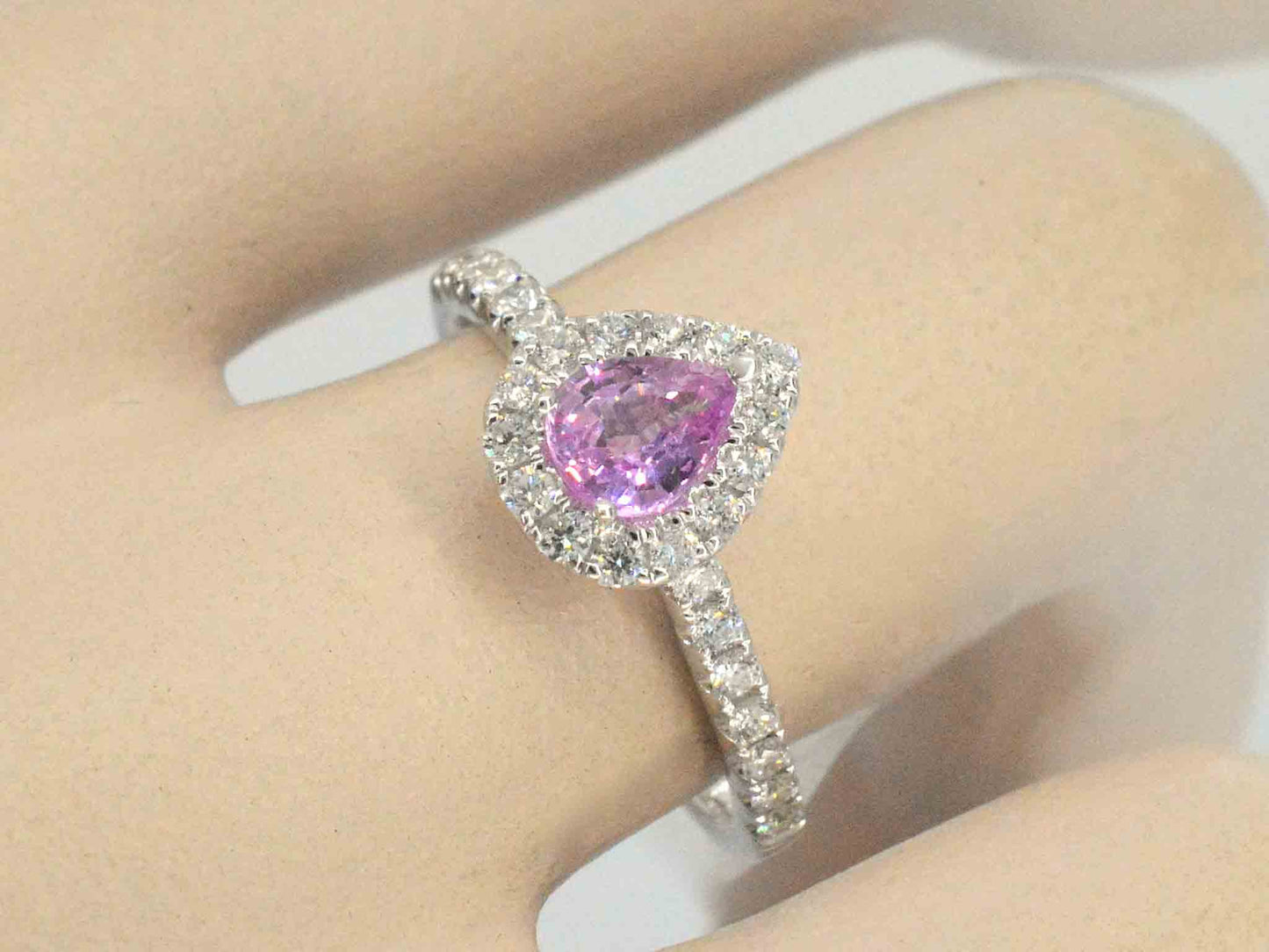 White gold entourage ring with a pink sapphire