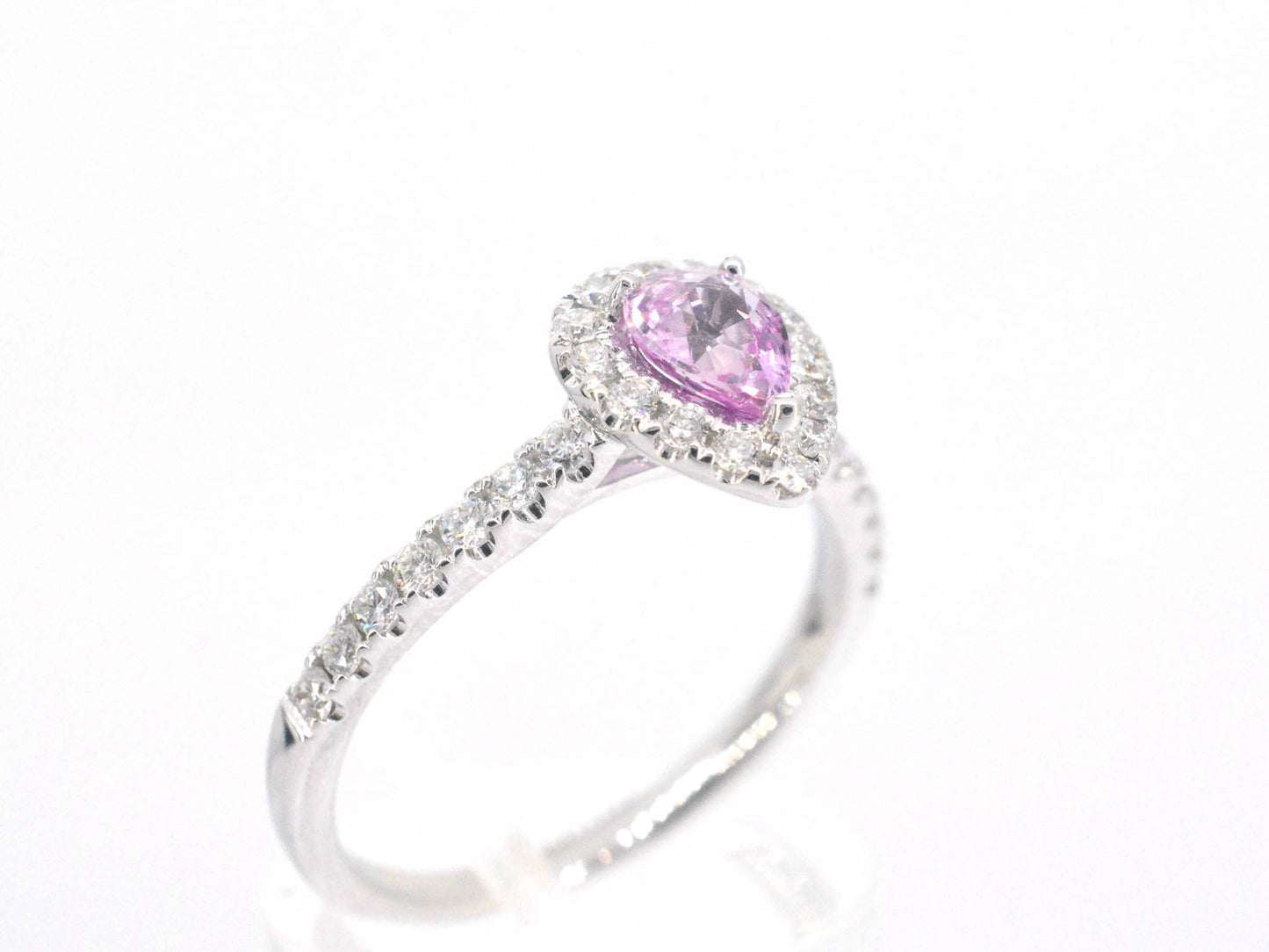 White gold entourage ring with a pink sapphire