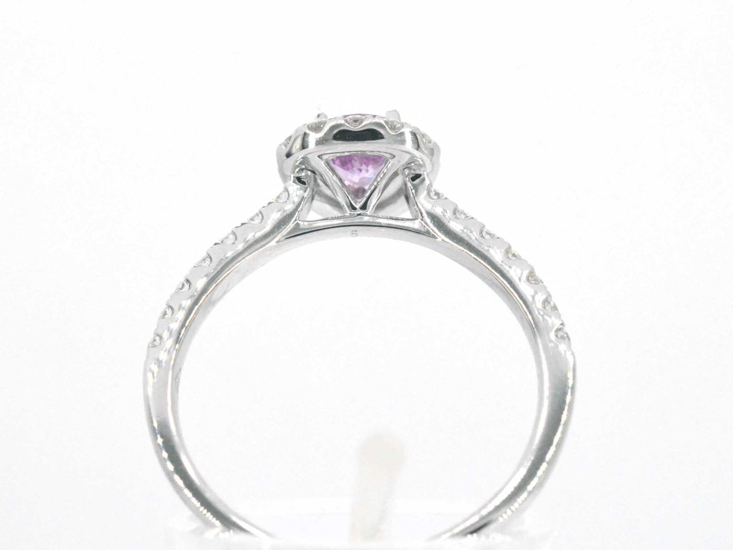 White gold entourage ring with a pink sapphire