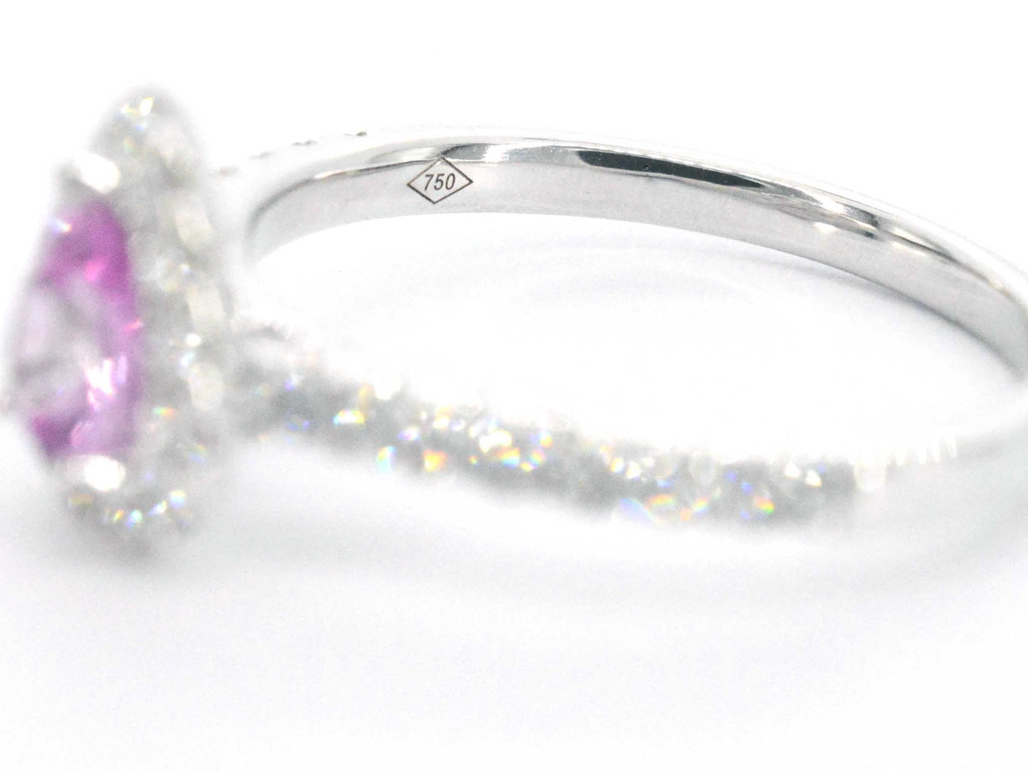 White gold entourage ring with a pink sapphire