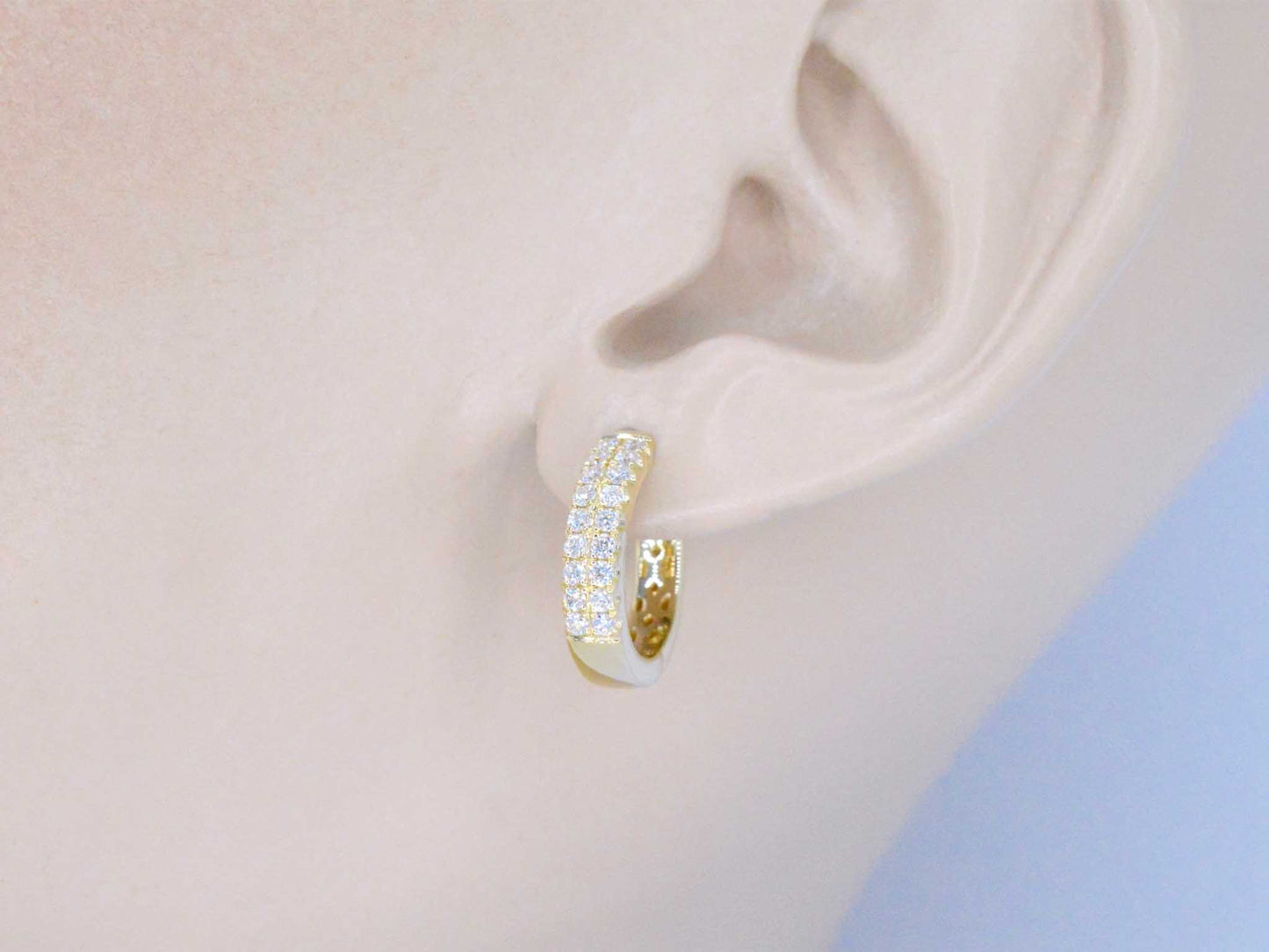 Gold hoop earrings with two rows of diamonds