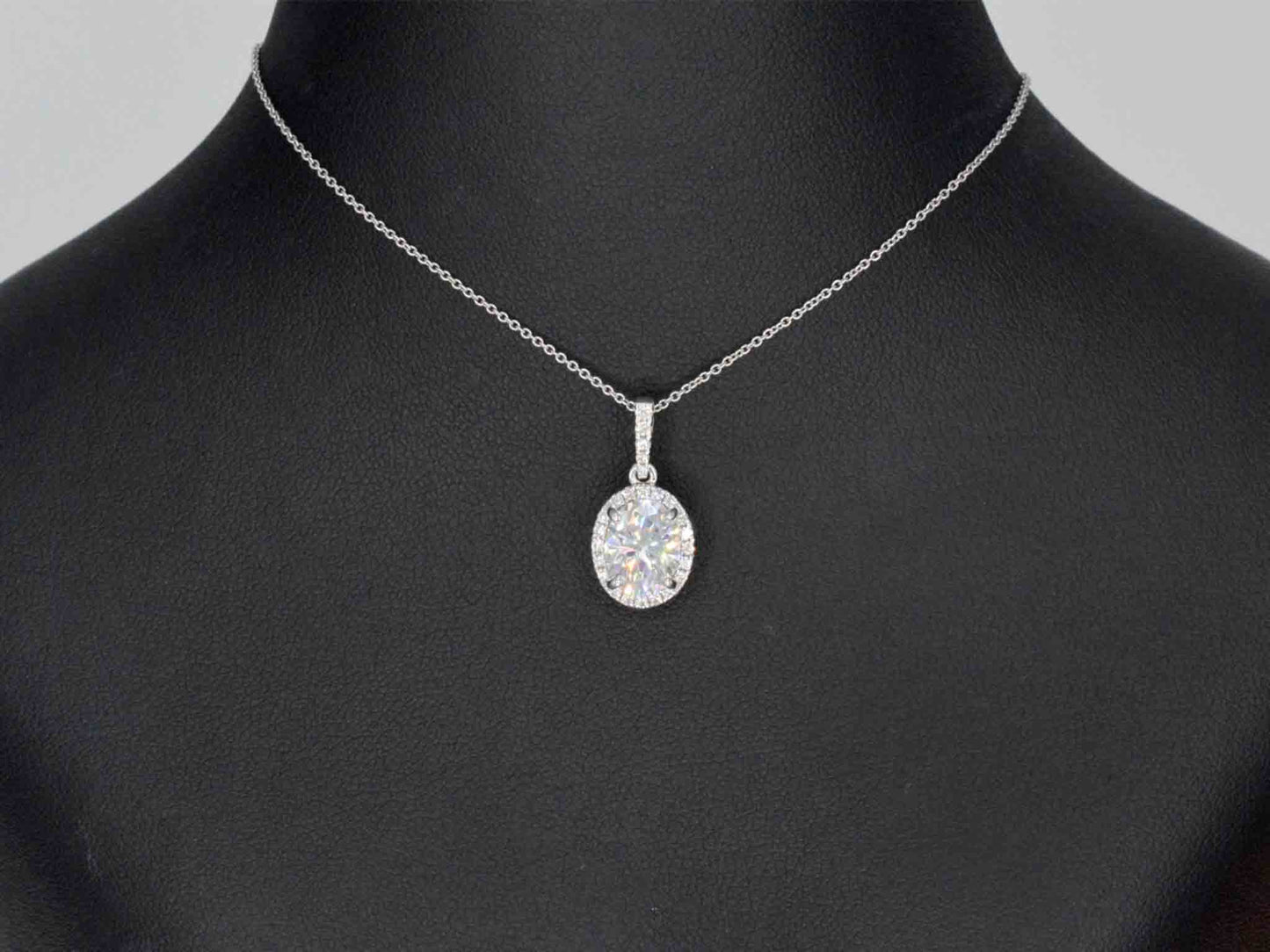18 carat white gold pendant with diamonds and an oval brilliant