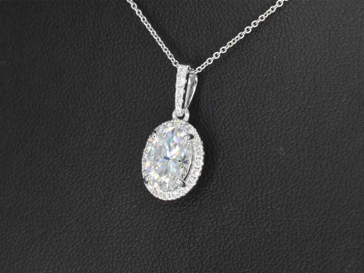 18 carat white gold pendant with diamonds and an oval brilliant