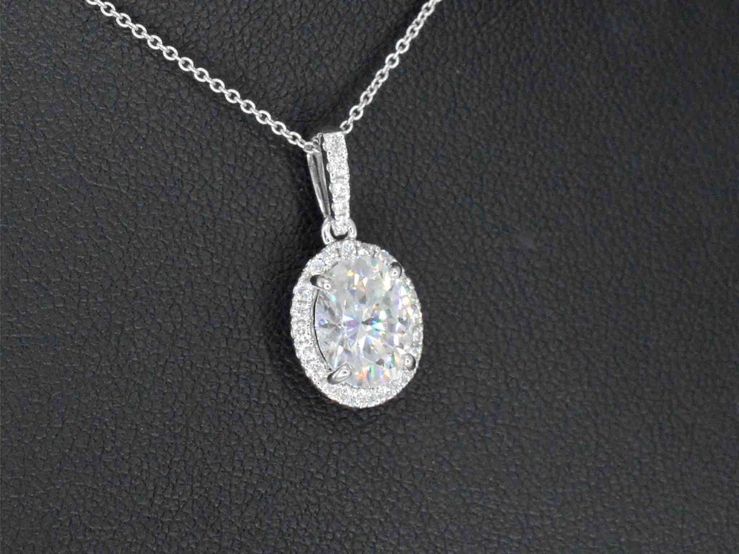 18 carat white gold pendant with diamonds and an oval brilliant