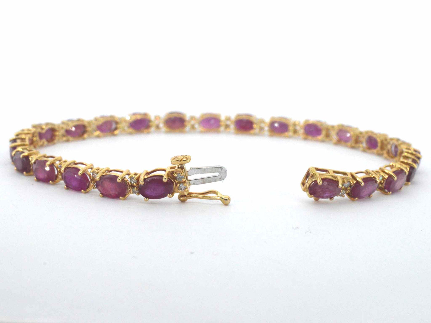 Gouden tennisarmband met diamanten en robijn