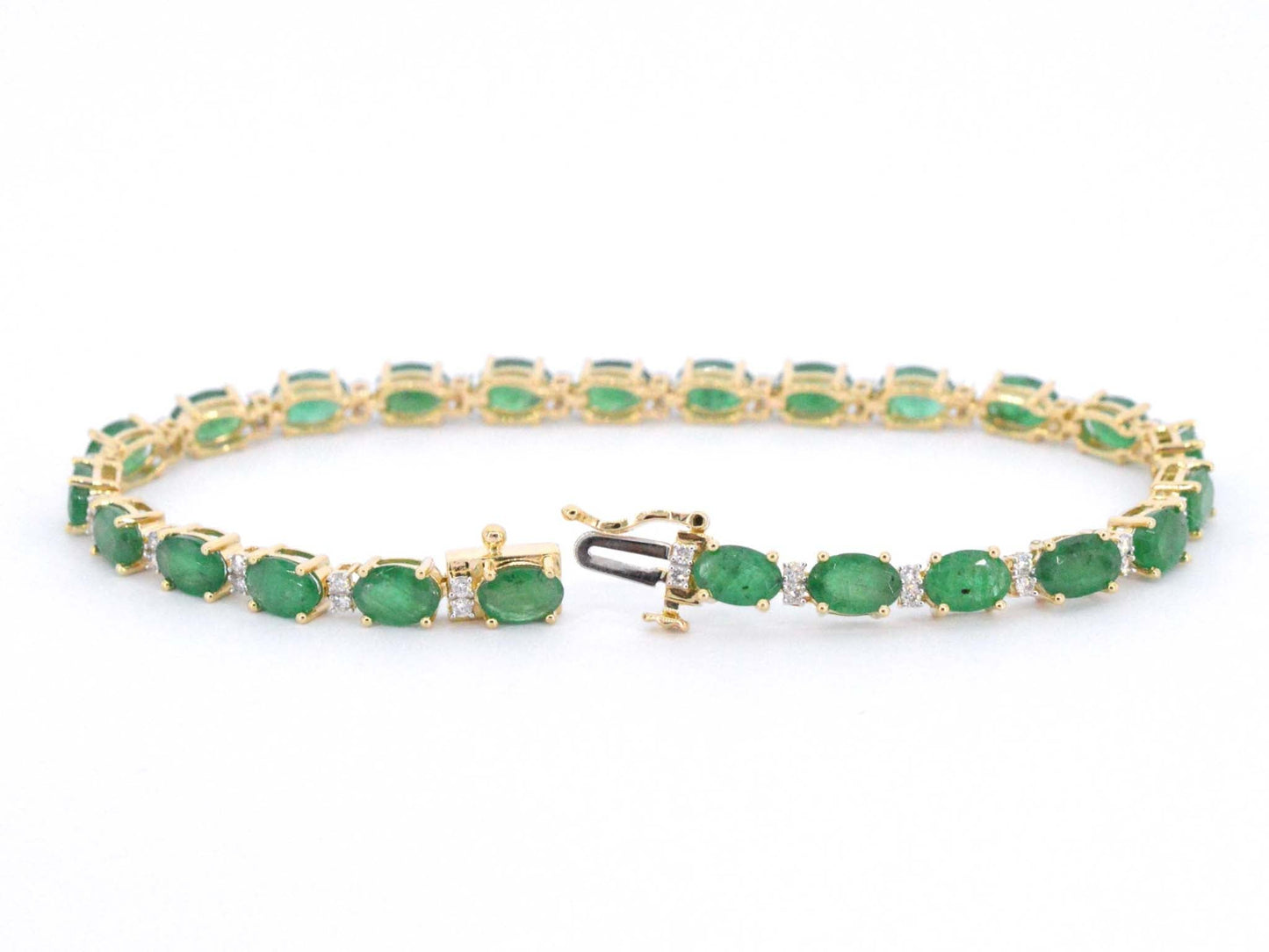 Geelgouden tennisarmband met diamanten en smaragden