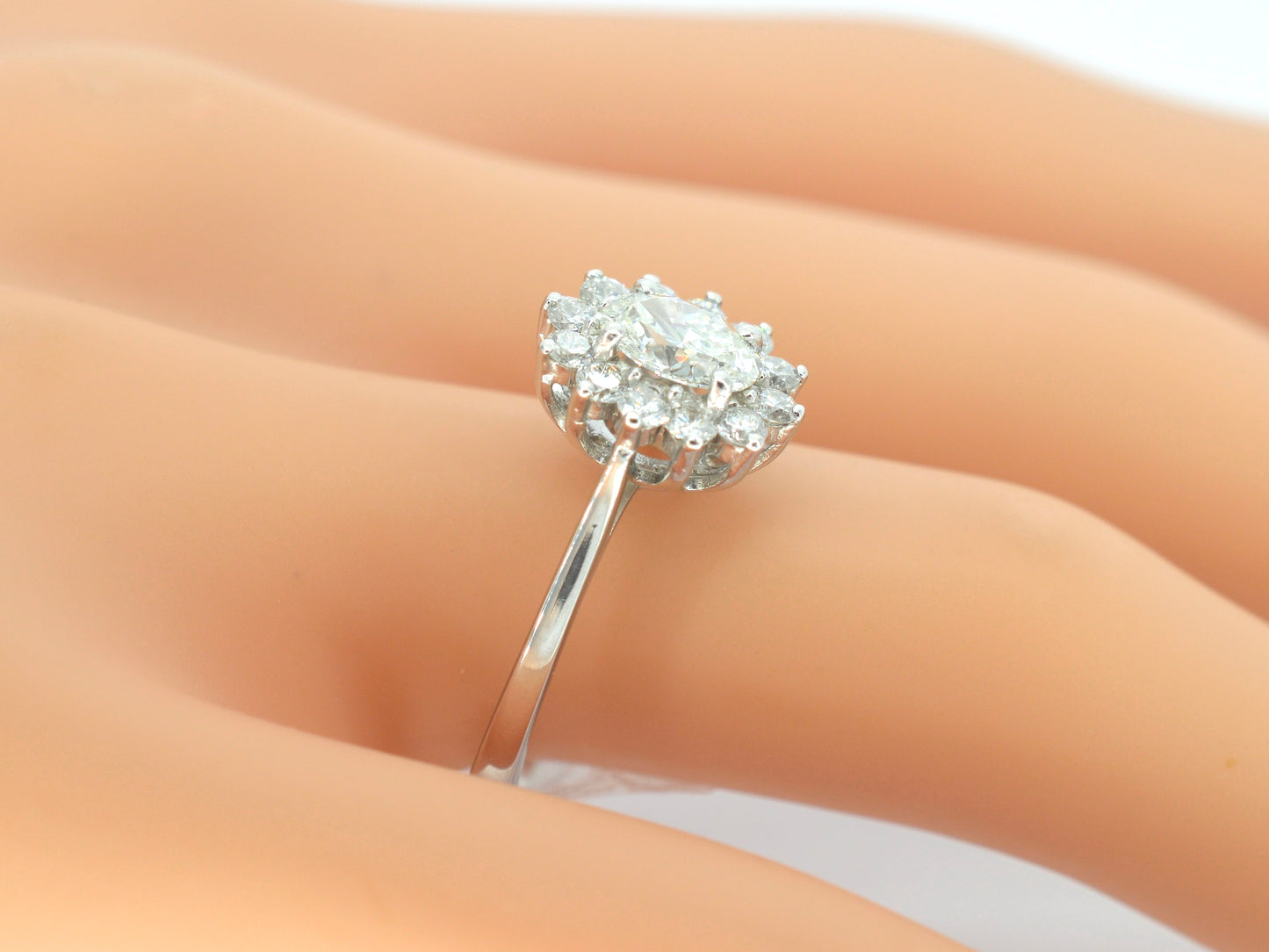 Platina entourage ring met een ovale diamant